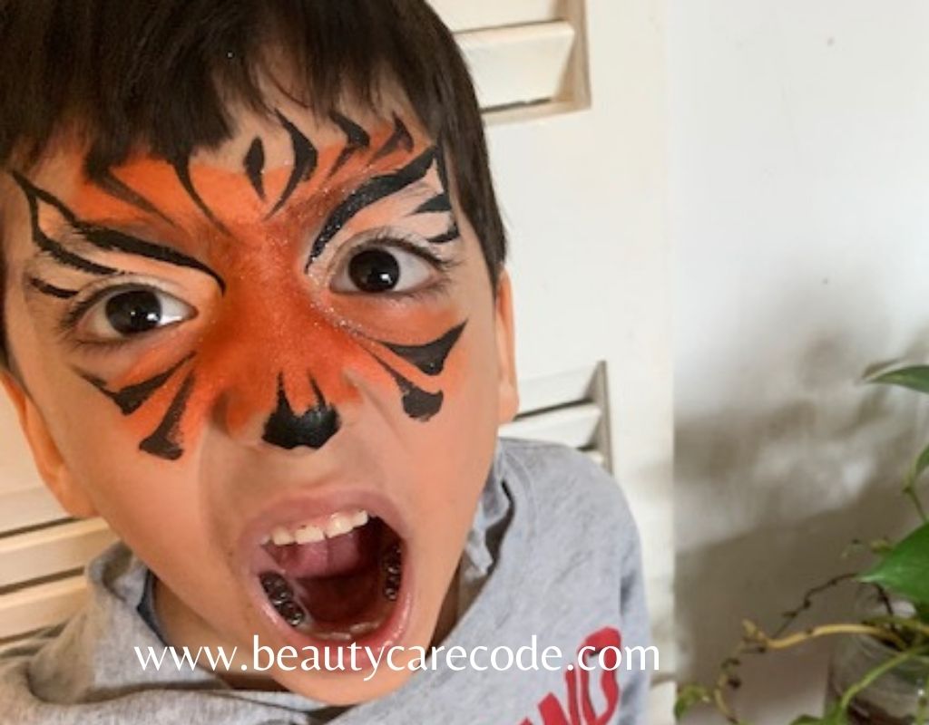 An image of a kid with face paint as a tiger to describe super safety tips for kids Halloween face paint